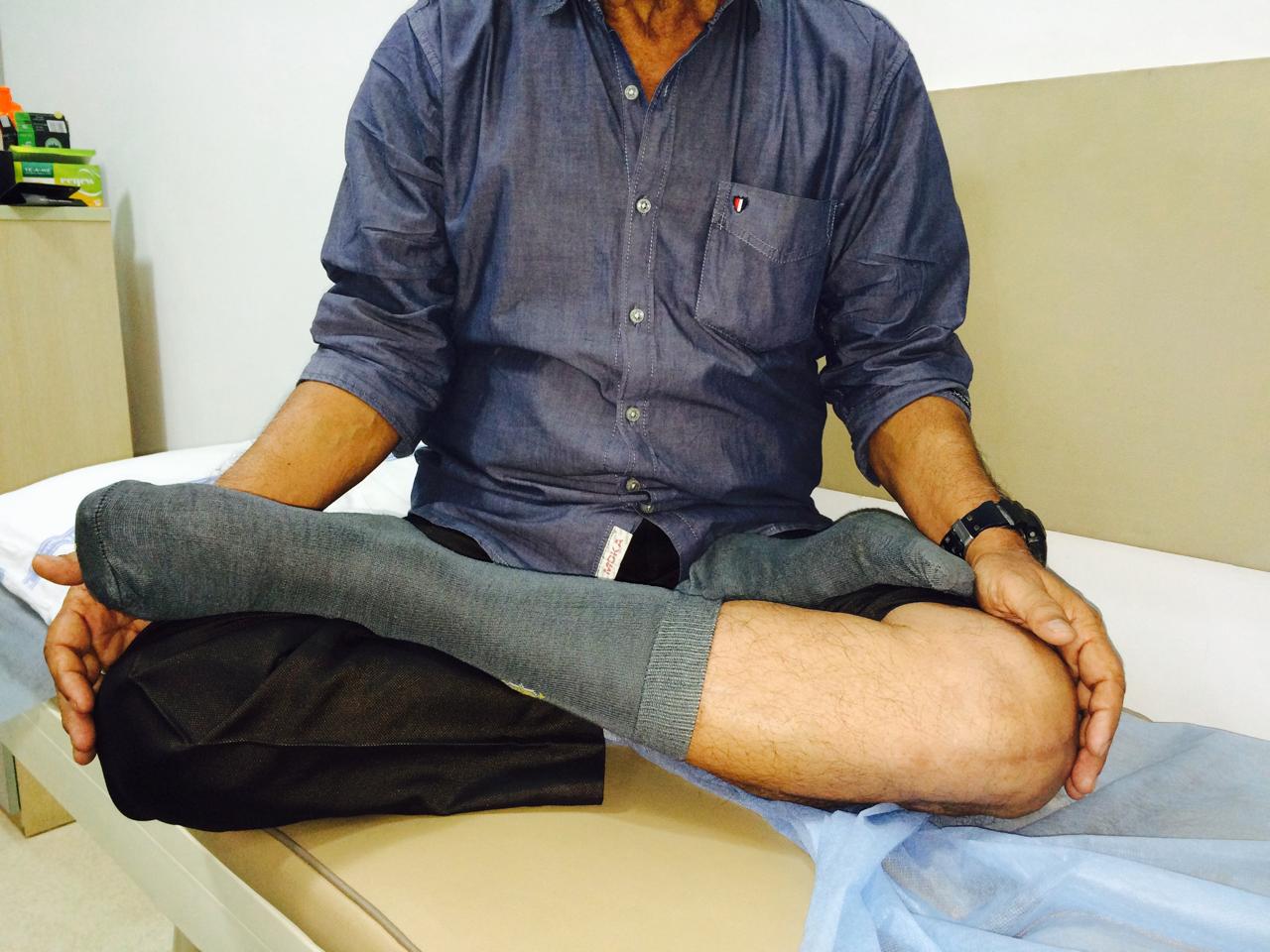 Patient sitting cross-legged after high flex knee replacement surgery with Dr. Vinay Joshi in Mumbai